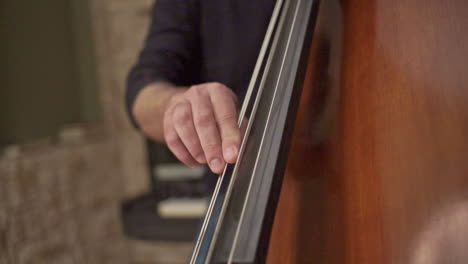 Close-Up-Footage-Of-A-Musician-Playing-A-Double-Bass-With-Finger-Slapping