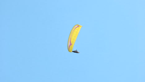 Flying-paraglider-on-blue-sky,-freedom-and-adventure-concept,-adrenaline-sport
