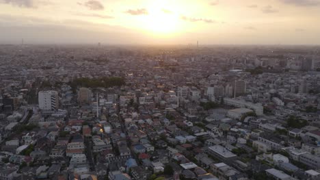 Aerial-shot-of-Tokyo-city-during-sunset,-concrete-jungle-all-over-the-horizon
