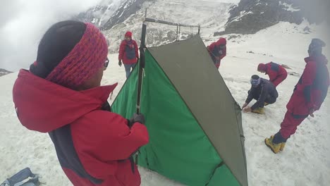 Tent-pitching-by-Himalayan-mountaineers-for-their-stay-in-upper-Himalayas-snowy-peaks
