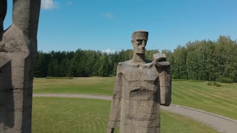 Aerial-shot-flying-towards-three-big-statues-in-Salaspils-Memorial