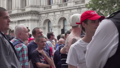 Tommy-Robinson-supporters-chant-argue-with-police-along-Whitehall,-London