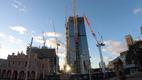 Hyperlapse-of-pedestrians-walking-past-Parramatta-Square-construction-site-while-the-cranes-move-building-material-in-and-around-site