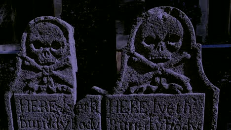 Ancient-tombstones-in-a-churchyard-at-night-in-a-thunderstorm-in-Faversham,-Kent
