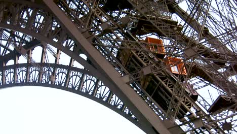 External-elevator-rising-on-the-Eiffel-tower-facade,-Paris,-France