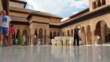 Very-low-angle-view-of-tourists-at-Lions-Court,-Alhambra,-Granada,-Spain