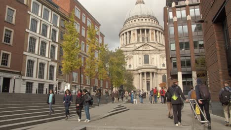 People-walking-towards-iconic-St-Paul's-Cathedral-in-London-alley