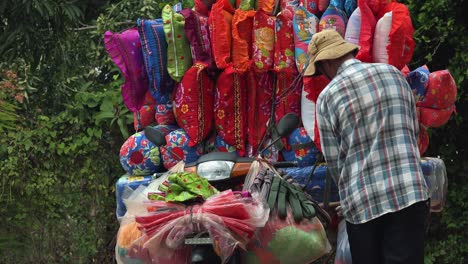 Vendor-Selling-and-Transporting-Colourful-Bedding-by-the-Side-of-the-Street