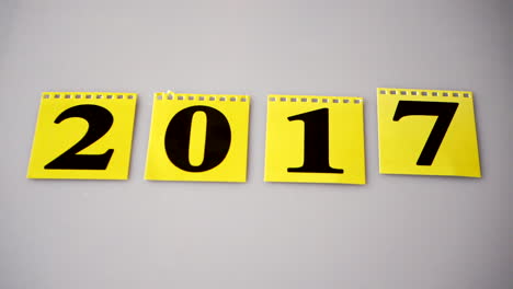 Yellow-flip-calendar-changes-to-a-new-year-hand