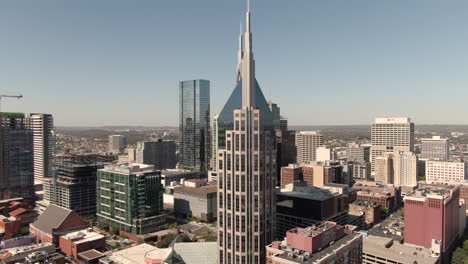 Circling-aerial-view-of-downtown-Nashville,-Tennessee-on-a-clear,-fall-day