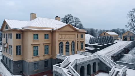 Drone-is-circling-the-snow-covered-palace-of-Gunnebo-in-Sweden,-Göteborg