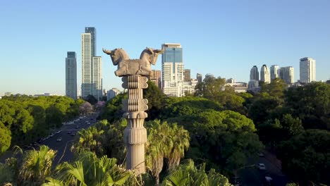Aerial-parallax-shot-of-a-Persian-column-in-Bosques-de-Palermo-and-Buenos-Aires-city