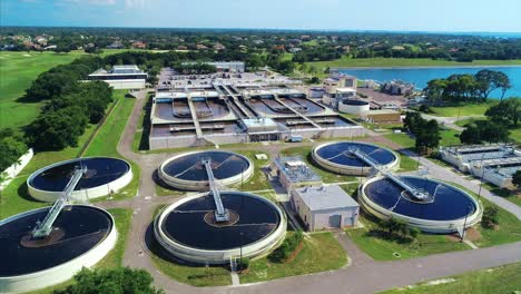 Flying-around-a-water-treatment-plant-by-a-body-of-water