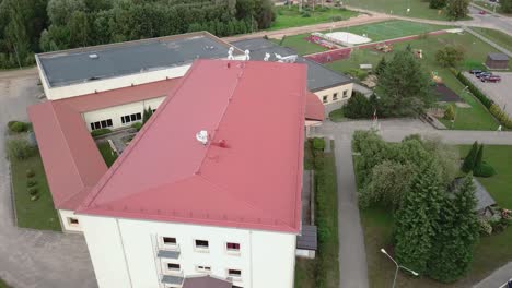 Aerial-flying-over-elementary-school-in-Smiltene,-Latvia-in-the-day