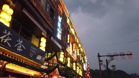 Wulingyuan,-China---August-2019-:-Advertising-neon-over-chinese-restaurant-in-bustling-part-of-Wulingyuan-town,-Hunan-Province