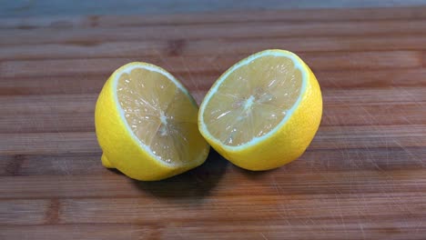 Slider-Shot-of-Sliced-Lemon-Halves-on-a-Wooden-Chopping-Board-in-the-Kitchen