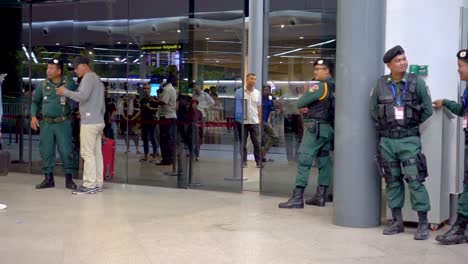 handheld-footage-Nov-2019,-Phnom-Pehn,-Cambodia:-the-doors-of-Phnom-Pehn-international-airport-heavily-guarded-in-anticipation-of-the-return-from-exile-of-the-opposition-party-leader