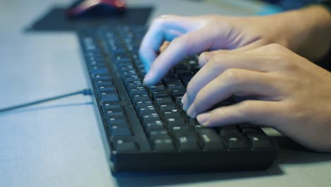 Man's-hands-typing-on-PC-keyboard-in-the-office