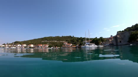 A-small-boat-approaches-village-Polace,-island-Mljet-in-Croatia