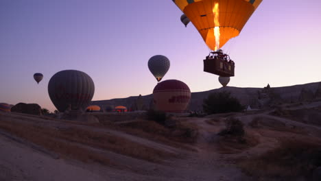 Wide-angle-view-of-flame-shooting-into-Cappadocia-hot-air-balloon-in-flight-during-sunrise