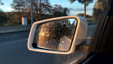 Close-up-shot-of-sunset-reflection-in-side-mirror-of-car,steady