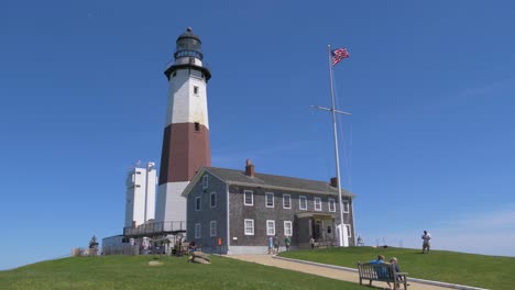 Establishing-shot-of-Montauk-Point-Lighthouse-Museum-under-renovation-on-a-sunny-summer-day,-June-2019