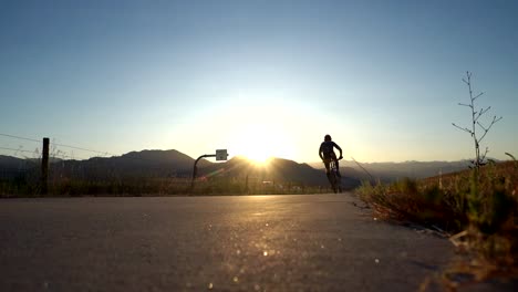 Biker-riding-on-bike-trail-along-the-highway-in-slow-motion