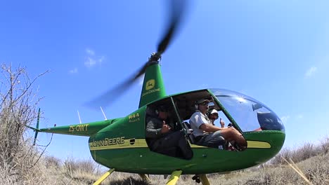 John-Deere-branded,-Robinson-Raven-II-helicopter-takes-off-in-Madikwe