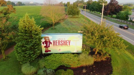Welcome-to-Hershey-billboard,-aerial-drone-tilt-down-shot