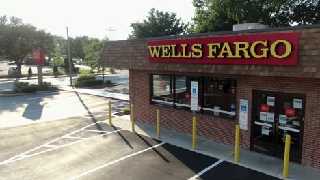 Wells-Fargo-bank-branch-entrance,-aerial-pull-back-reveals-one-of-largest-financial-institutions-in-USA,-small-town-America