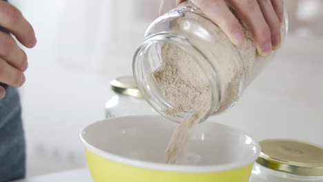 Slow-motion-as-pouring-almond-flour-in-the-kitchen,-gluten-free-ingredients