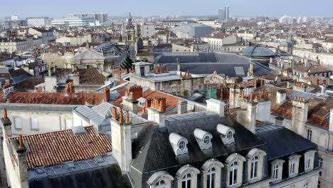 Church-of-Notre-Dame-in-Bordeaux-France-along-with-the-dome-of-Les-Grands-Hommes-commercial-center,-Aerial-pedestal-reveal-shot