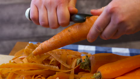 Peeling-fresh,-ripe,-whole-carrots