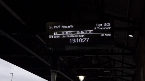 Timetable-display-in-train-station-platform-wide-shot