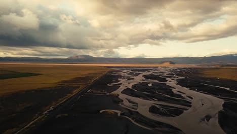 Various-shots-by-drone-of-an-icelandic-glacial-river-in-beautiful-sunset-light