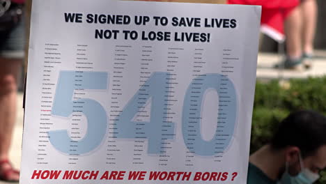 On-the-National-Health-Service-staff-Pay-Justice-a-placard-says,-“We-signed-up-to-save-lives-not-to-lose-lives”-above-the-number-540,-the-number-of-NHS-workers-killed-by-Coronavirus