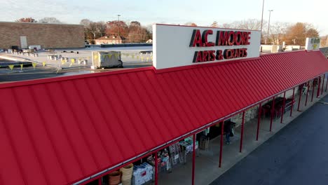 AERIAL:-AC-Moore-Arts-Crafts-Store-as-customers-carrying-shopping-bags-exit,-going-out-of-business