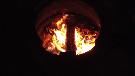 Slow-motion-burning-wood-logs-on-fire-in-a-barrel-at-night