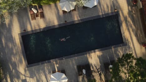 Aerial-drone-birdseye-view-shoot-a-man-swimming-in-the-pool-nice-sunshine-with-camera-rotate-a-circle_Dalat-VietNam-22Aug2020_4K-24fps