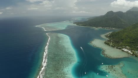 Aerial-establishing-shot-of-Mo'orea-island-coastline-and-reef-barrier-in-French-Polynesia