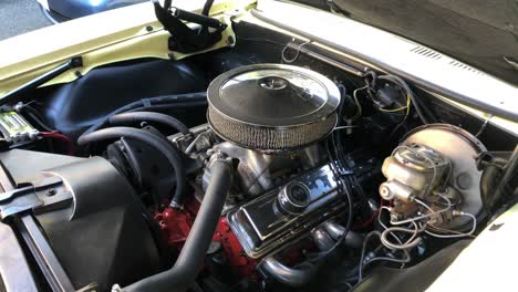 Under-hood-of-classic-car-with-engine,-medium-shot-time-lapse