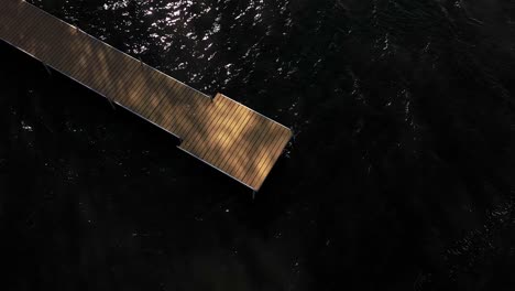 dock-on-top-of-dark-water-aerial