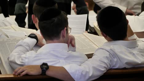 Two-young-Jewish-men-in-Yeshiva-school-studying-Torah,-religious-writings
