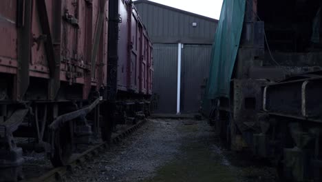 Stationary-wooden-cargo-train-carriages-wide-panning-shot