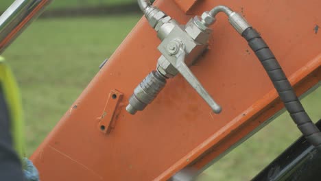 Engineer-threading-on-hardware-for-hydraulics-on-excavator