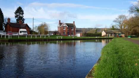 Rural-idyllic-landmark-canal-boathouse-Autumn-countryside-boating-path-dolly-right