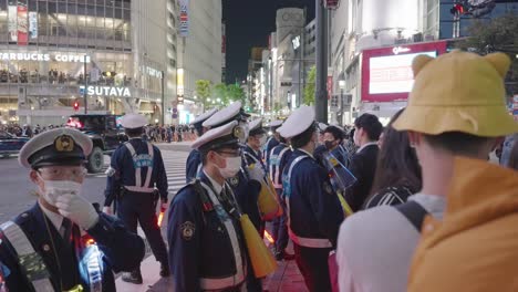 Police-Officers-Wearing-Masks-At-The-Shibuya-Crossing-On-Halloween-Night-In-Tokyo,-Japan---slow-motion