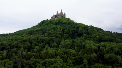 Aerial-of-Hohenzollern-Castle-on-Hilltop-Surrounded-by-Green-Forest