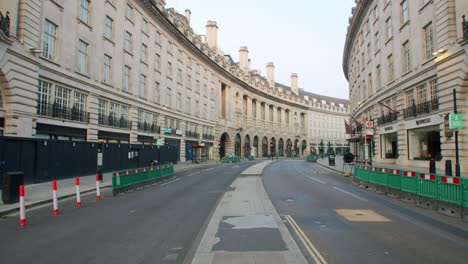 Lockdown-in-London,-empty-Regent-Street,-with-COVID-19-social-distancing-barriers-and-signs,-during-the-COVID-19-pandemic-2020
