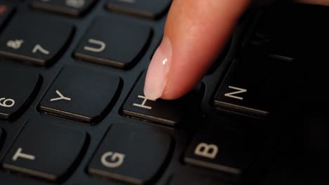 Pushing-H-button-on-the-black-keyboard